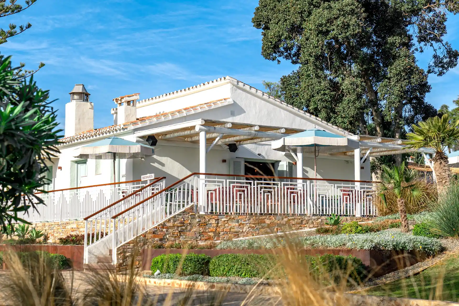 Whitewashed guest bungalow with terrace in the Boho Club gardens