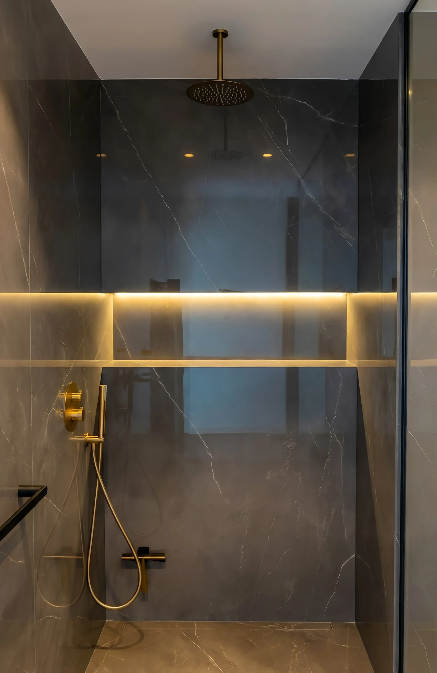 Walk-in shower with brass fittings and LED lighting